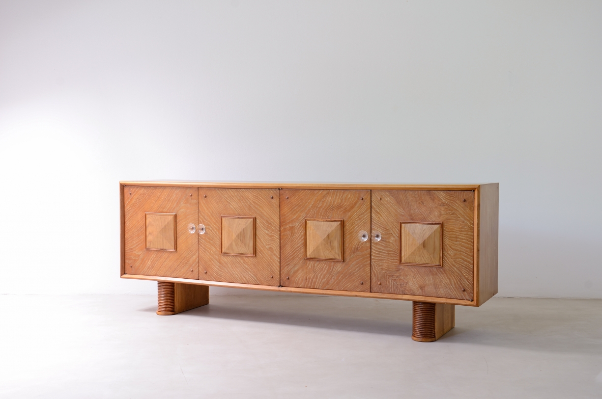 Large 4-door oak cabinet with central diamond decorative motif and curved wood bases, 1940.