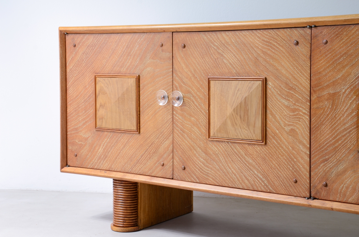 Large 4-door oak cabinet with central diamond decorative motif and curved wood bases, 1940.