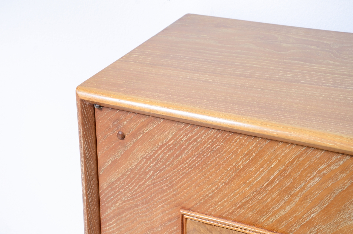 Large 4-door oak cabinet with central diamond decorative motif and curved wood bases, 1940.