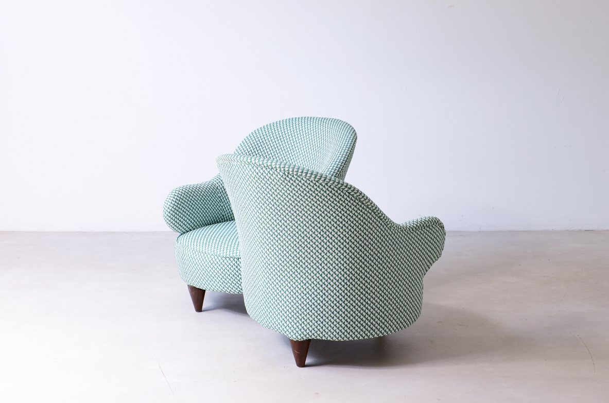 Conversation sofa for two, upholstered in padded fabric.  Italian manufacture, ca.1950.