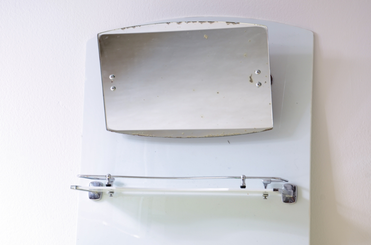 White opaline bathroom mirror with tilting mirror, shelf, and chrome-plated soap dish.1930