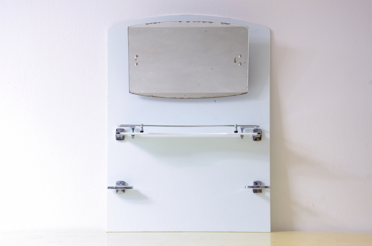 White opaline bathroom mirror with tilting mirror, shelf, and chrome-plated soap dish.1930