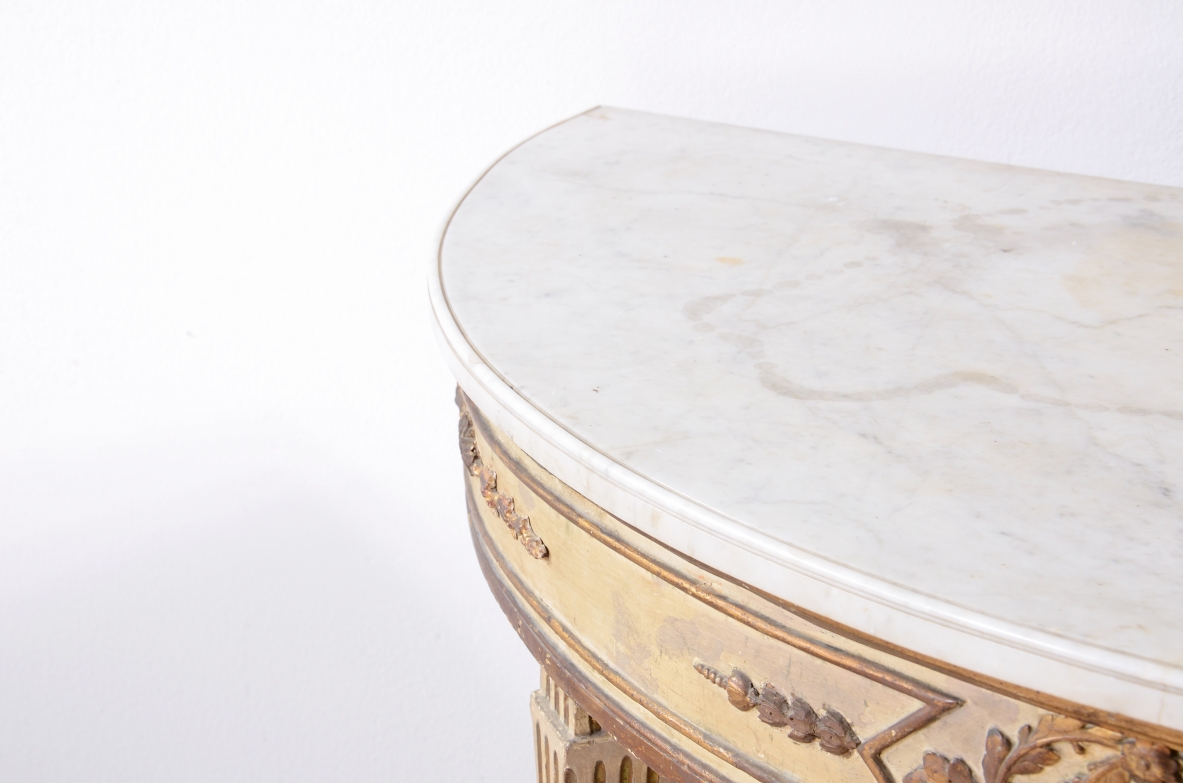 Pair of elegant half-moon console tables in lacquered and gilded wood, Louis XVI period, ca. 1770.