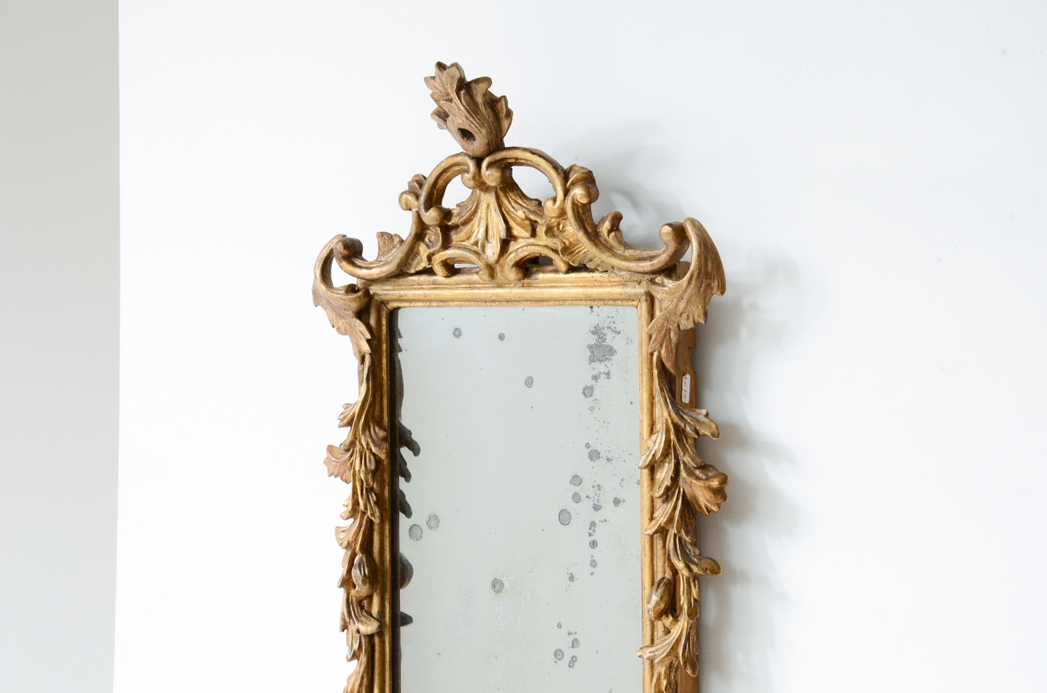 Pair of very refined and elegant carved and gilded wooden mirrors, 1730-1750
