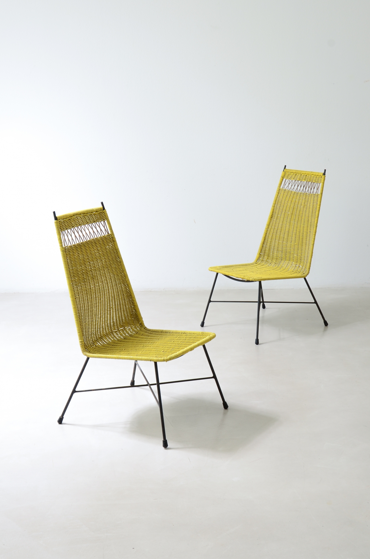 Pair of armchairs with an iron frame and woven rubber and rattan thread.Saporiti Italia, ca. 1950.