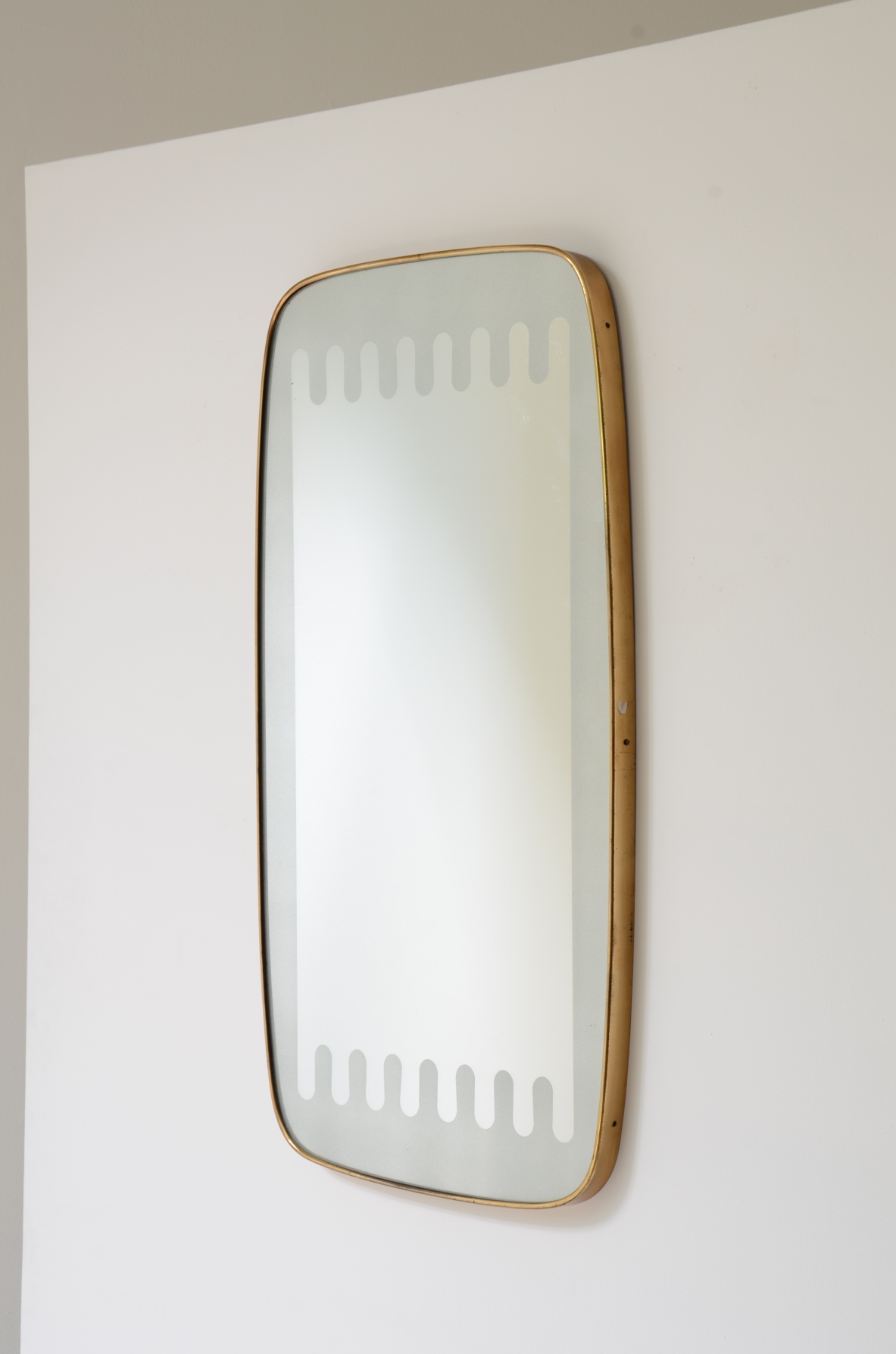 Pietro Chiesa  Elegant shaped mirror with a refined satin wave finish. Fontana Arte manufacture, ca.1950.