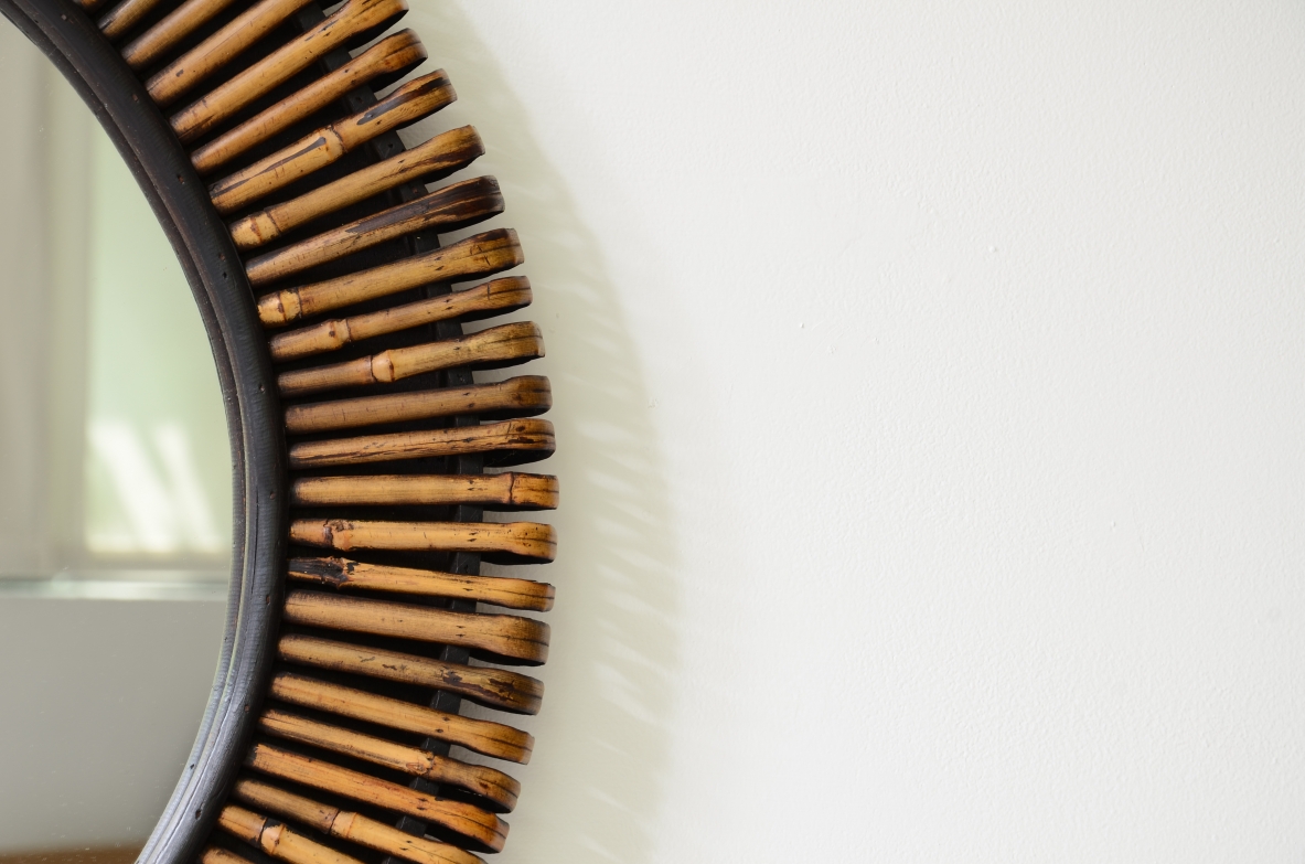 Beautiful mirror with a sunburst cane frame.  Italian manufacture, circa 1950-60.