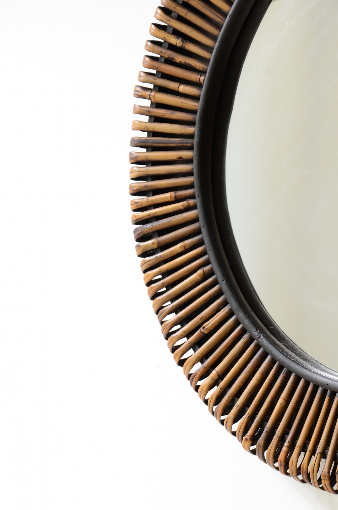 Beautiful mirror with a sunburst cane frame.  Italian manufacture, circa 1950-60.