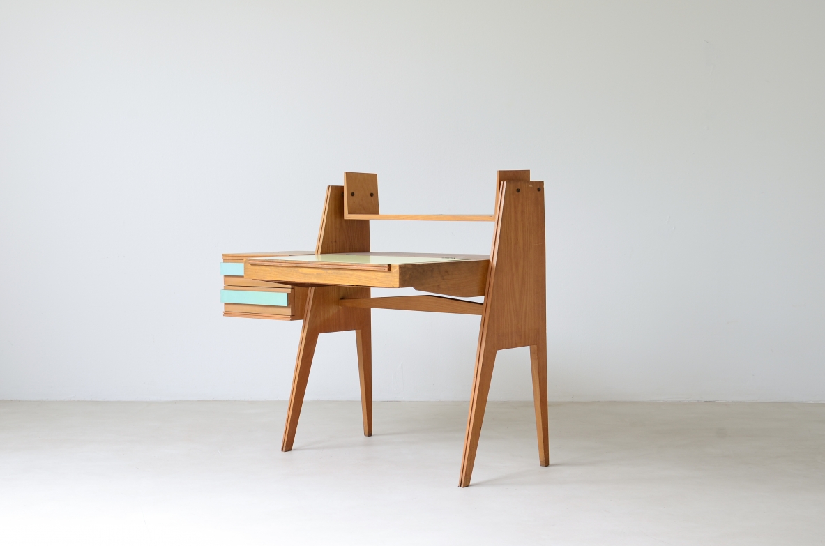 Ico Parisi (1916-1996)  Bedroom writing desk in oak with compartment for objects and shelf. Two drawers on the right side. Top and drawers with original period polypropyleneapplications.  Italian manufacture, 1955.